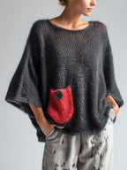Oversized black wool blend sweater for women, front view on model