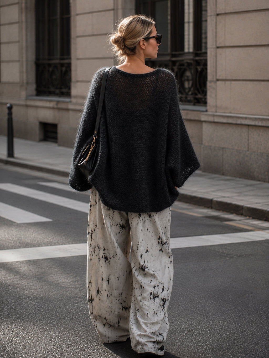 Black sweater showing the relaxed batwing sleeves