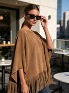 Tassel fringe trim across the full hem of the tan poncho