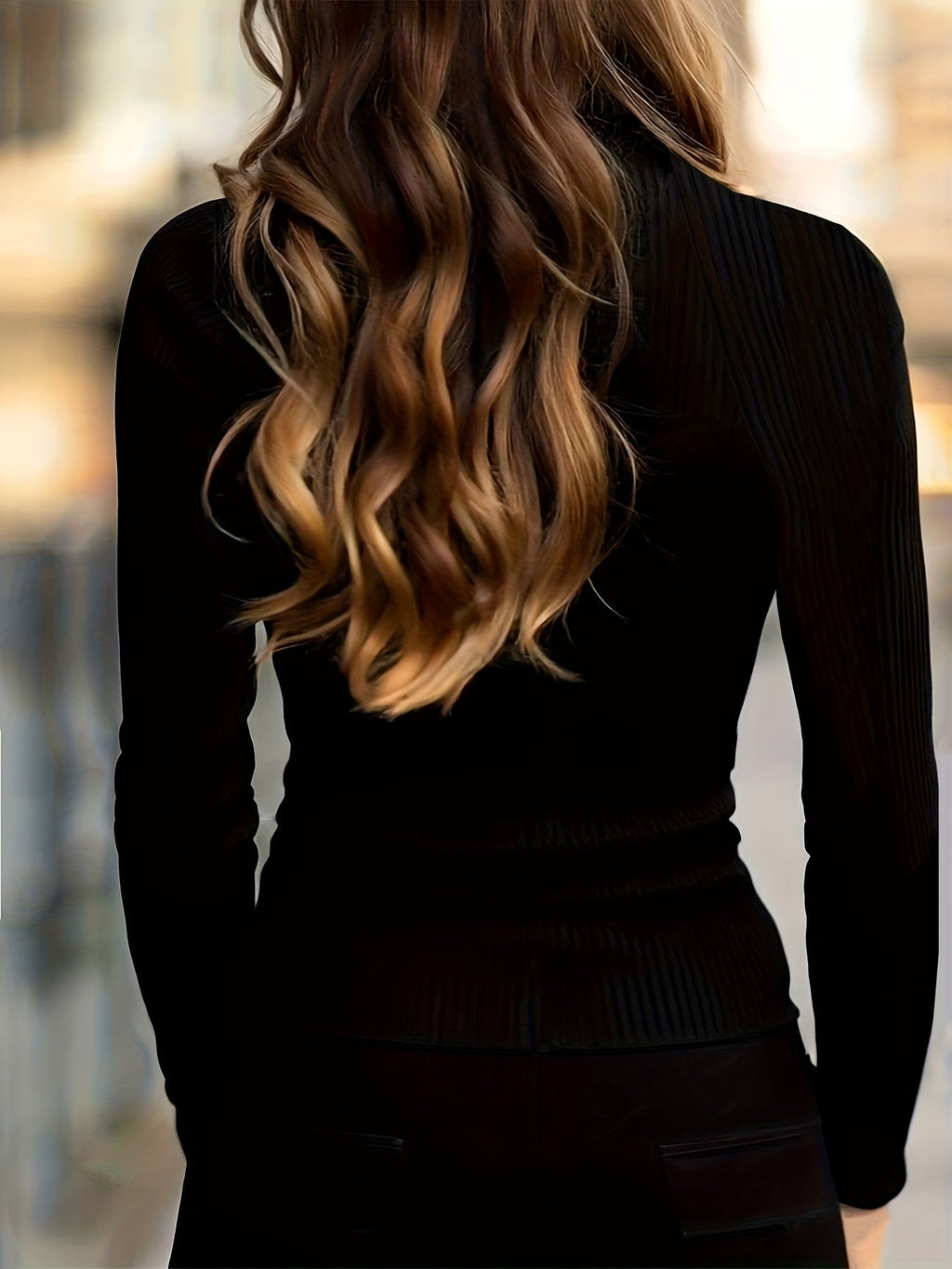 Ribbed turtleneck top worn with the collar zip opened at the throat