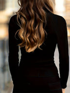 Ribbed turtleneck top worn with the collar zip opened at the throat