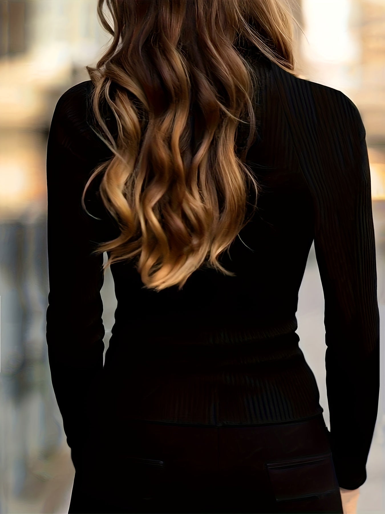 Ribbed turtleneck top worn with the collar zip opened at the throat