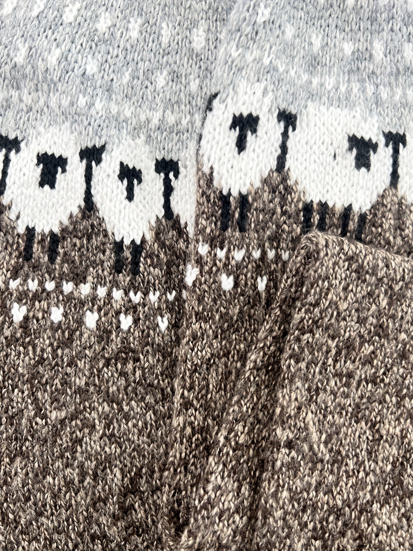 Sheep jacquard sweater detail at the sleeve and cuff