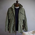 Men's M-65 field jacket in green, front view on model