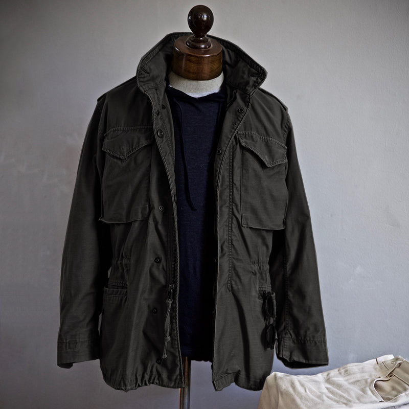 M-65 field jacket worn over a hoodie, three-quarter view