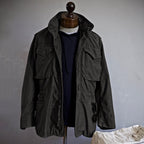 M-65 field jacket worn over a hoodie, three-quarter view