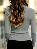 Long sleeve and cuff detail of the black ribbed turtleneck top