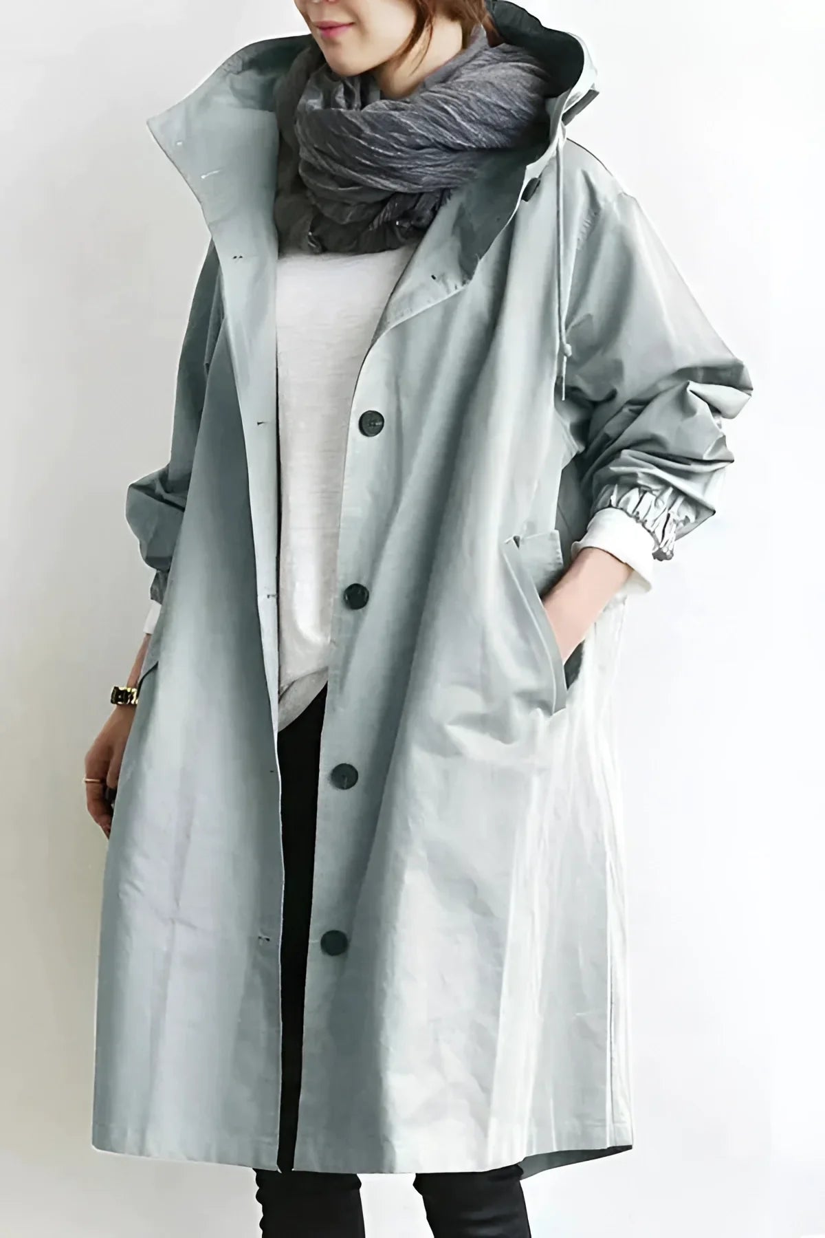 Oversized hooded raincoat for women in gray, front view with hood up