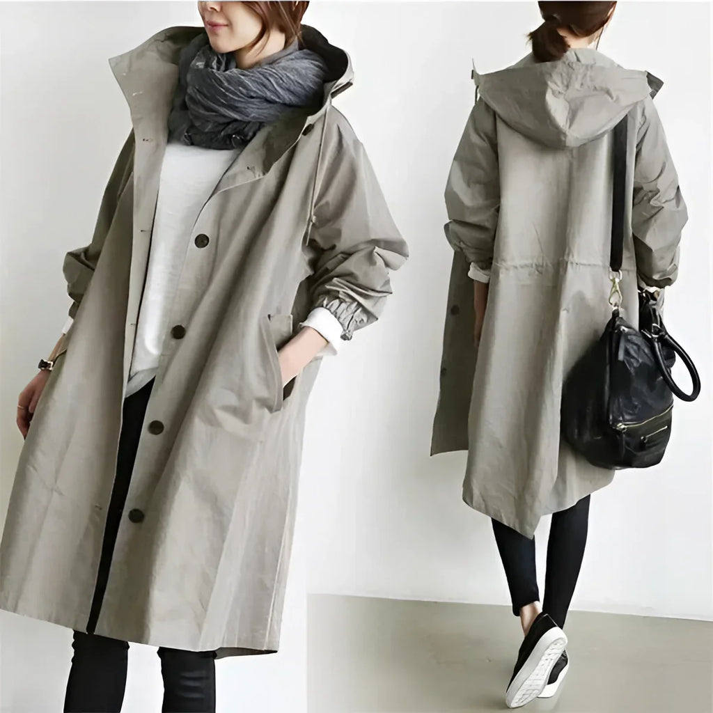 Oversized raincoat styled for a wet commute in a dark colorway