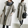 Oversized raincoat styled for a wet commute in a dark colorway