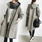 Oversized raincoat styled for a wet commute in a dark colorway