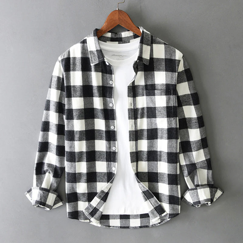 Men's plaid shirt worn open over a plain tee