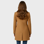 Close view of the funnel neck stand collar on the tailored long coat