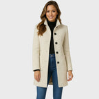 Back view of the women's funnel neck long coat showing the clean cut
