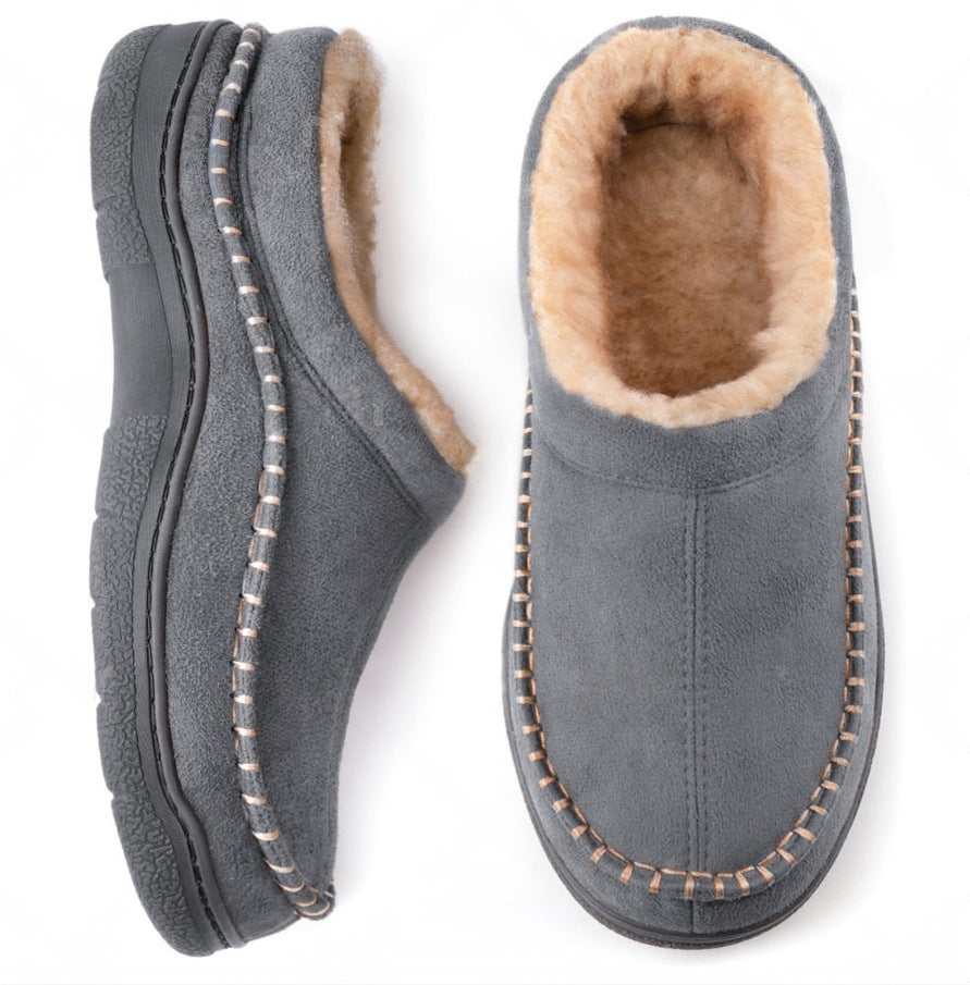 Men's moccasin slippers worn indoors on a wooden floor