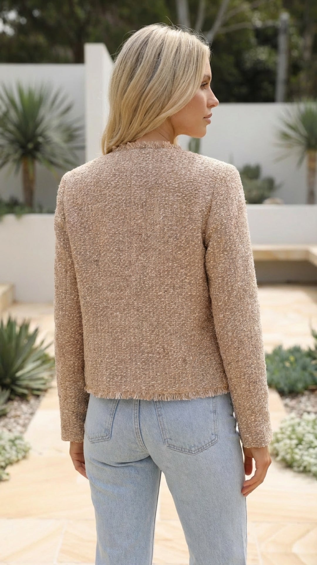 Women's cropped jacket in beige seen from the back