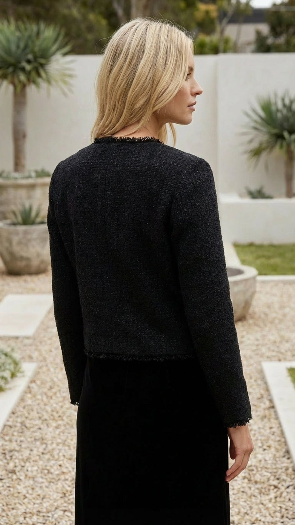 Women's cropped jacket in black seen from the back
