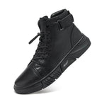 Men's black walking shoes worn with trousers on a hard floor