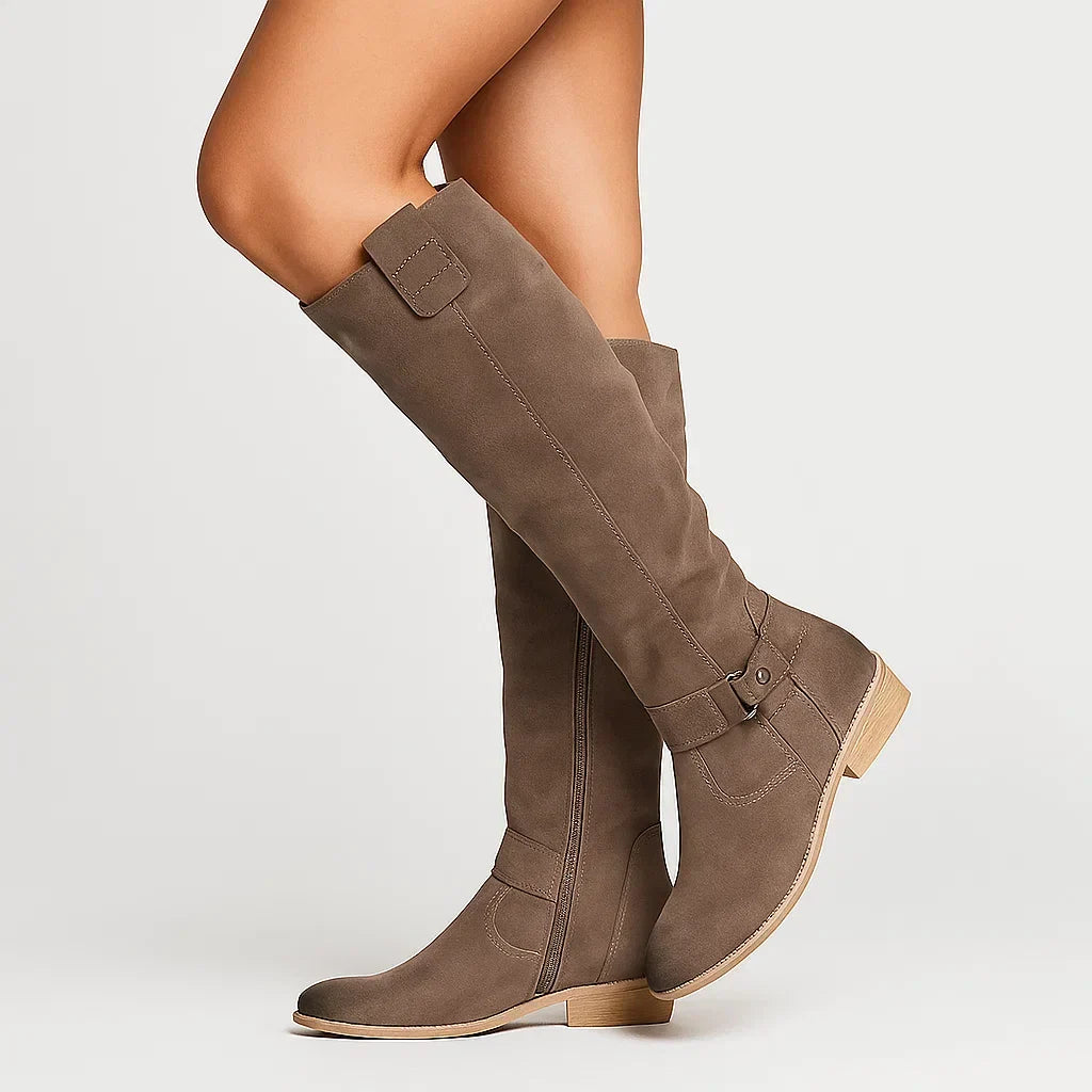 Side profile showing the low block heel and shaft height