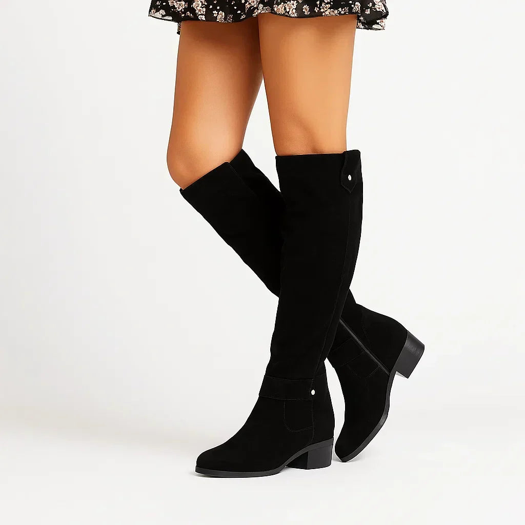 Suede knee high boots worn with jeans