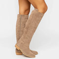 Knee high suede boots for women in beige, pair shown standing