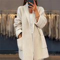 Open front cardigan sweater in beige, worn open with pockets visible