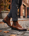 Men's brown suede Chelsea boots with brogue detailing, side profile