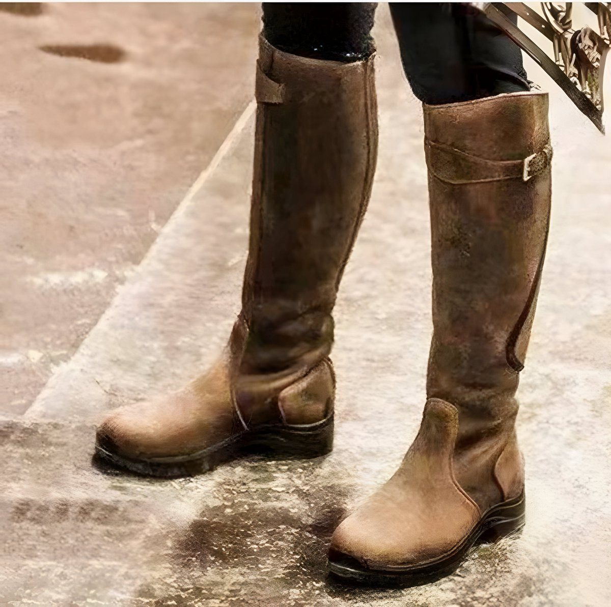 Knee high leather boots worn with slim denim