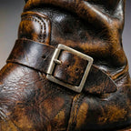 Close up of the polished metal buckle on the boot shaft