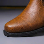 Close-up of the polished metal eyelets and leather stitching