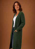 Green cable knit cardigan side view showing the longline hem