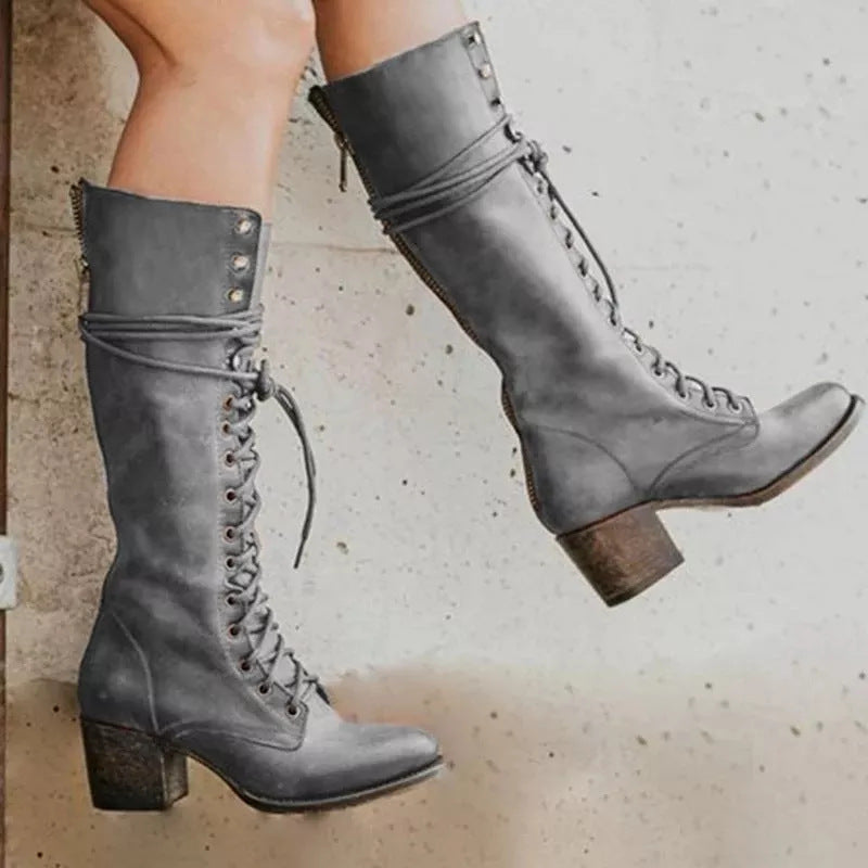 Lace up combat boot in reddish brown, showing the stacked block heel