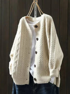 Oversized cable knit cardigan sweater — front view on model