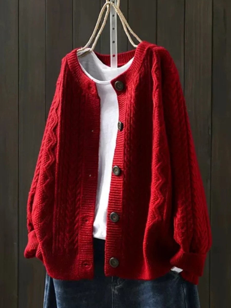 Oversized cable knit cardigan sweater — back view on model